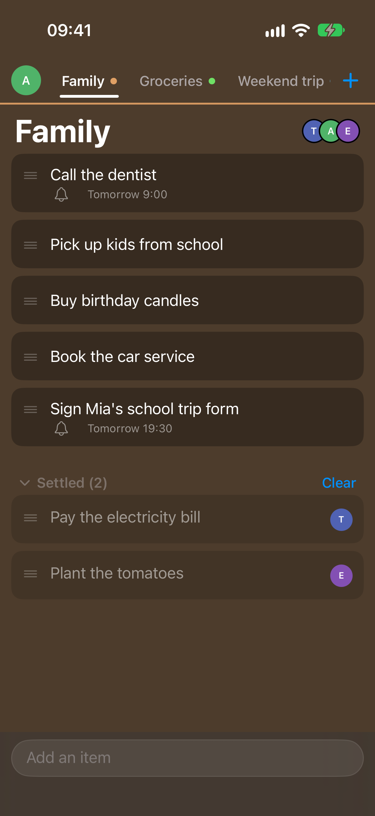 Anna's phone in dark mode, signed in as Anna: the same Family list with the same items and the same two settled items, on a deep brown screen.